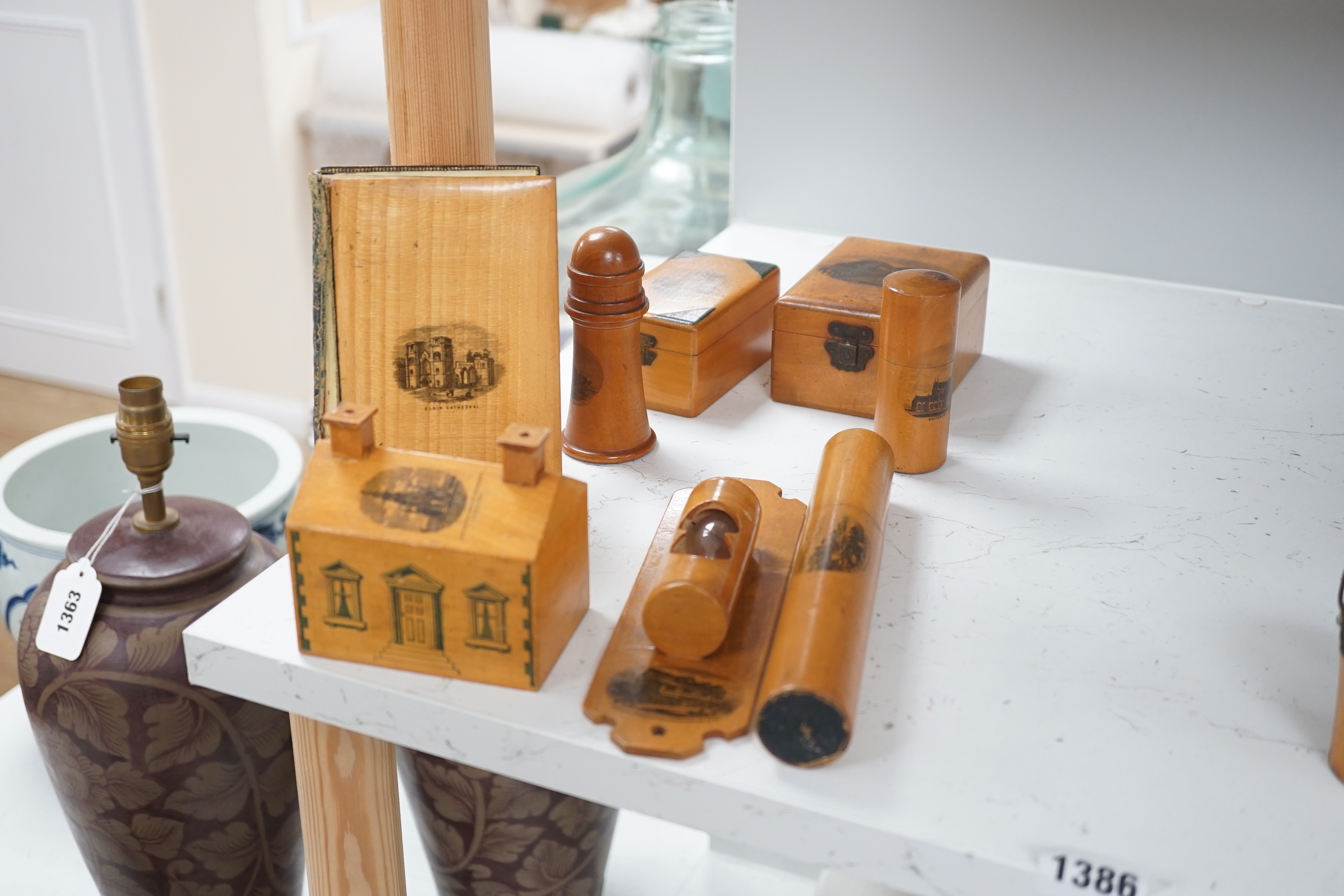 A collection of mixed Mauchline wares, including six egg cups on stand, a house money box, various boxes, letter openers and a Scottish song book, 14cm high (16)